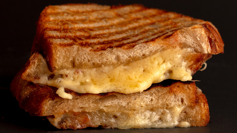 A closeup of a grilled cheese sandwich on sourdough bread