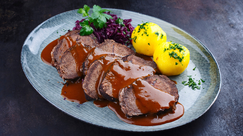 Traditional German sauerbraten on a gray table