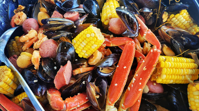 Seafood boil with mussels, sausage, crab legs, shrimp, and corn