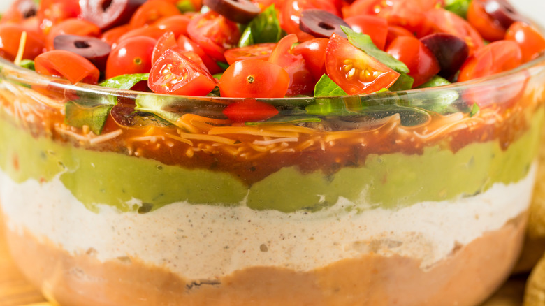Clear bowl of seven-layer dip