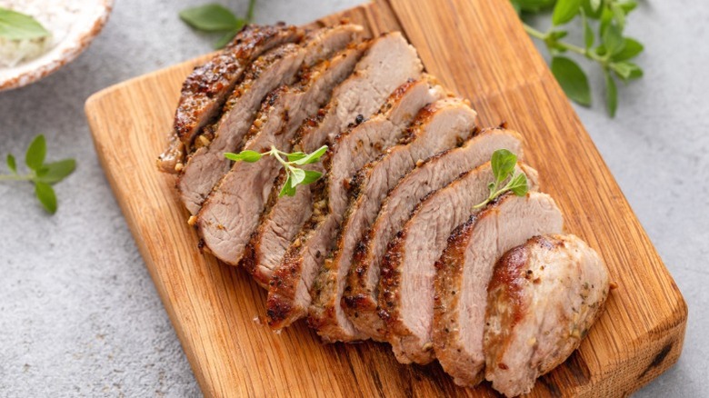 Roast pork sliced on a cutting board
