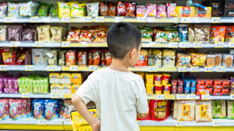 A child choosing candy at a store.