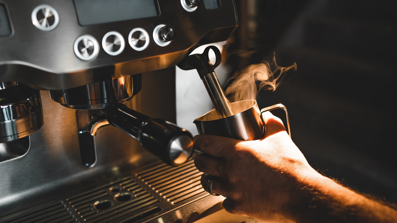 Steamer on coffee machine in use