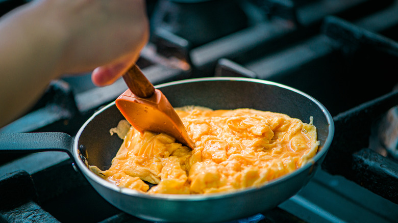 Scrambled eggs being cooked in pan