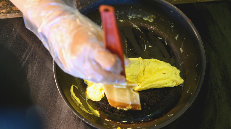 Scrambling eggs with rubber spatula