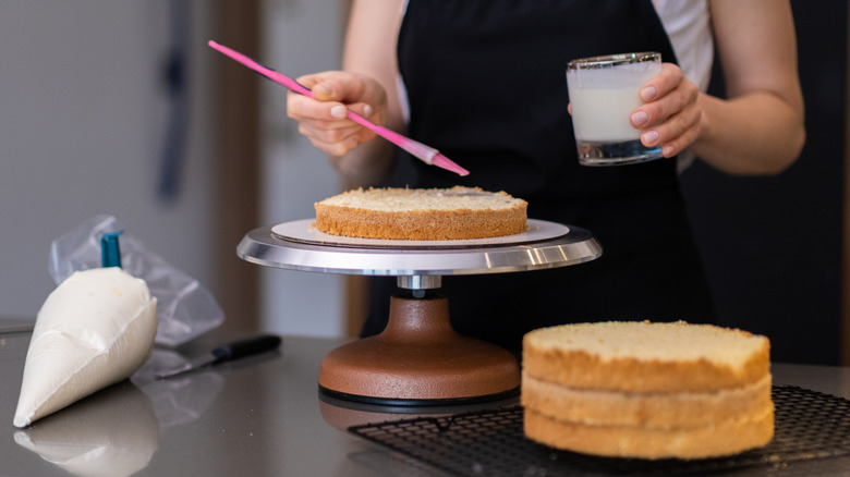 Brushing cake layers with cream