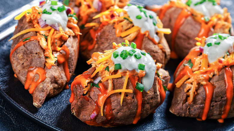 Stuffed sweet potatoes loaded with cheese, sour cream, and other toppings
