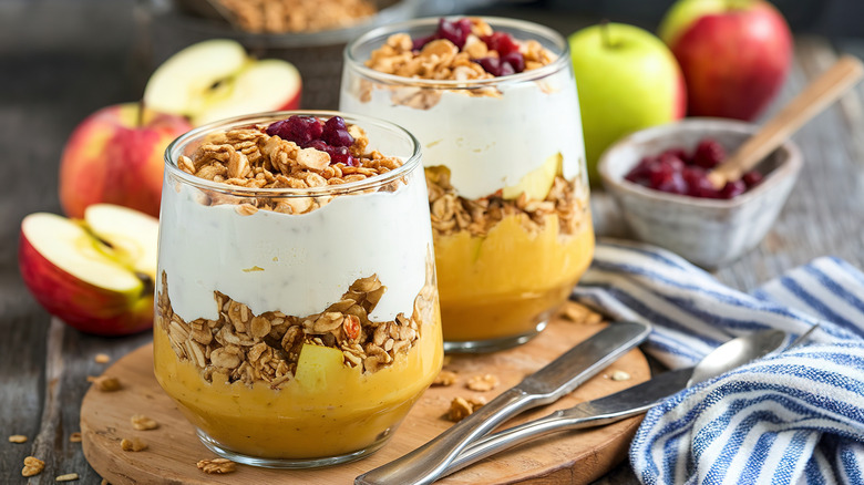 Glasses with layered yogurt, fruit, and granola parfaits