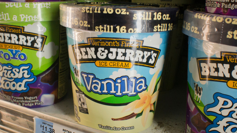 Ben & Jerry's vanilla ice cream pint on freezer shelf next to other Ben & Jerry's flavors