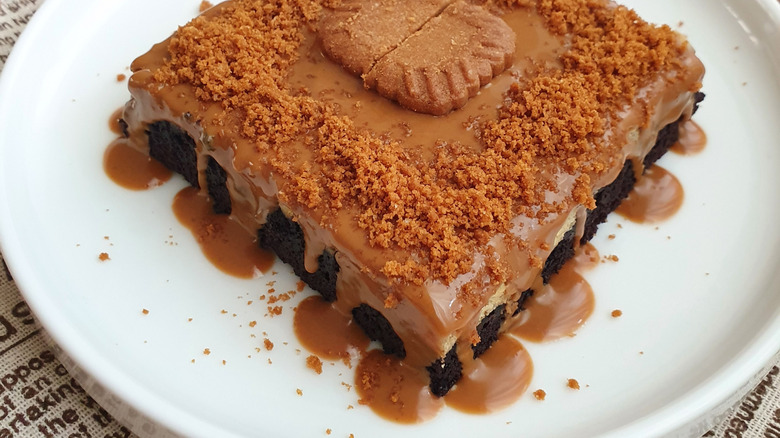 Biscoff and cream cheese brownie with crumbles and caramel on top.