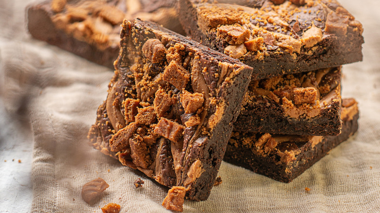 Biscoff brownies with Biscoff butter and crumbled cookies on top.