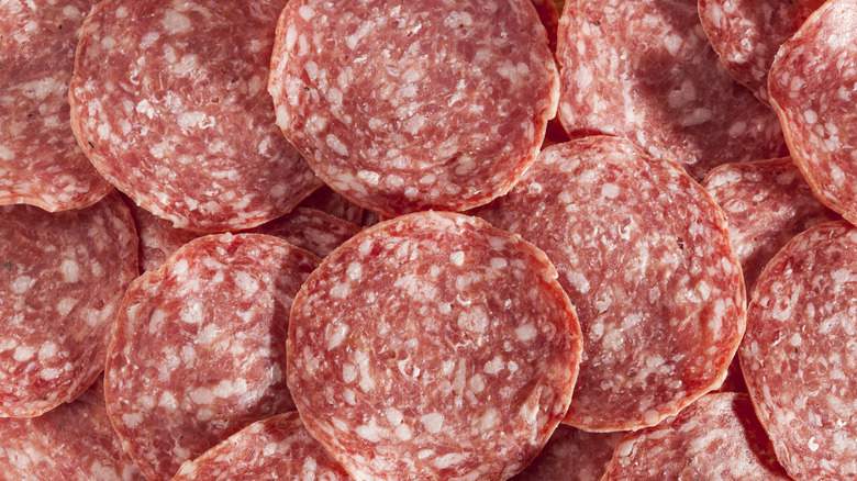 A stack of freshly cut pepperoni slices.