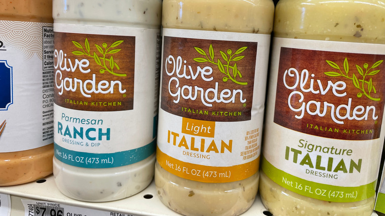 Bottles of official Olive Garden dressings on grocery store shelf