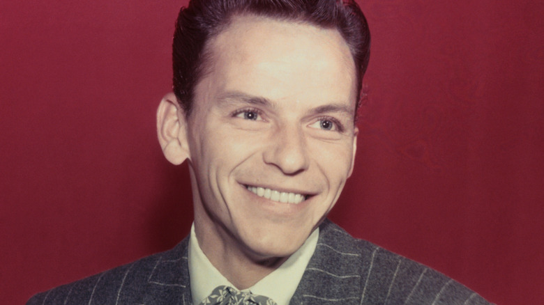 Frank Sinatra smiles in a striped jacket
