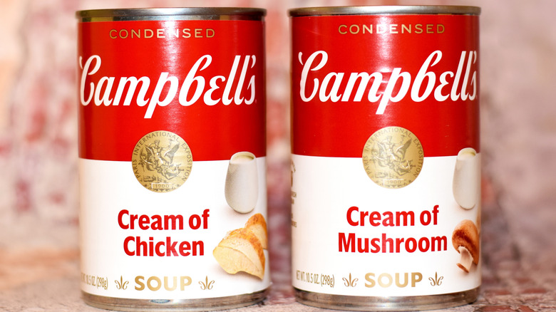 A can of Campbell's Cream of Mushroom Soup and a can of Campbell's Cream of Chicken Soup