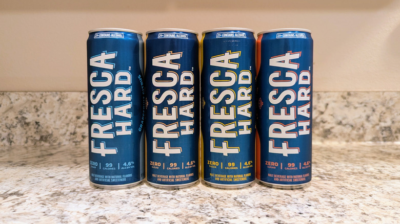 Hard Fresca cans in a lineup on a kitchen counter.