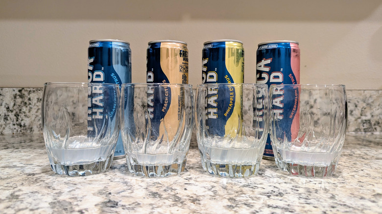 Hard Frescas poured into separate glasses on a kitchen counter.