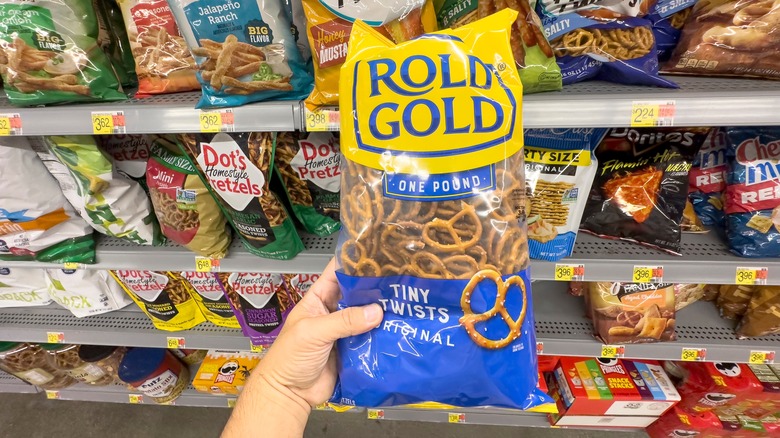Hand holding back of Rold Gold pretzels