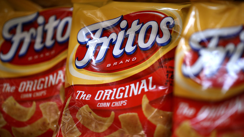 Bags of Fritos corn chips are displayed on a store shelf.