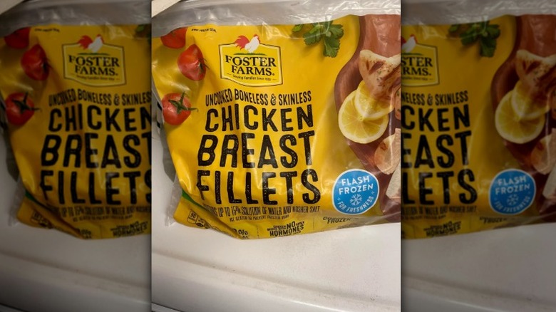 A bag of Foster Farms Uncooked Chicken Breast Fillets on a counter.