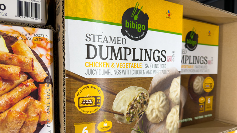 Boxes of Bibigo chicken and vegetable steamed dumplings in freezer aisle at Costco