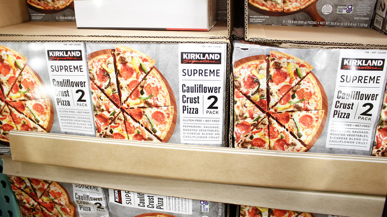 Rows of Kirkland Signature Cauliflower Crust Pizza in boxes in Costco freezer