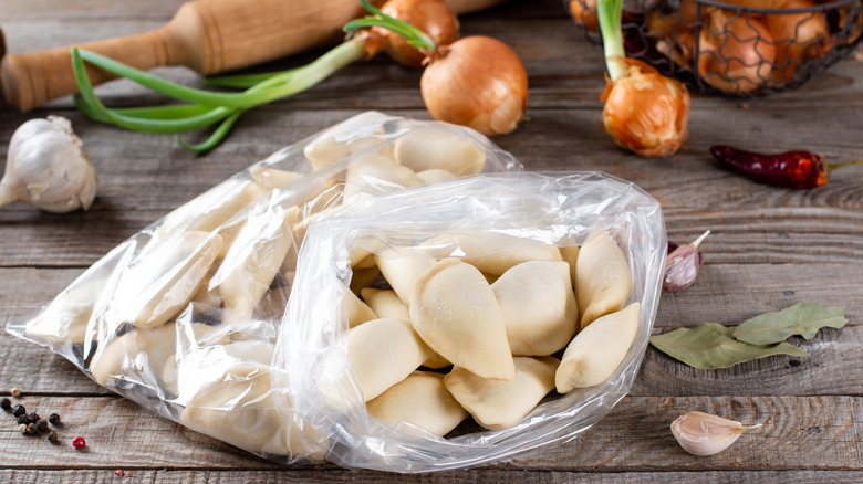 Uncooked frozen dumplings in a plastic bag
