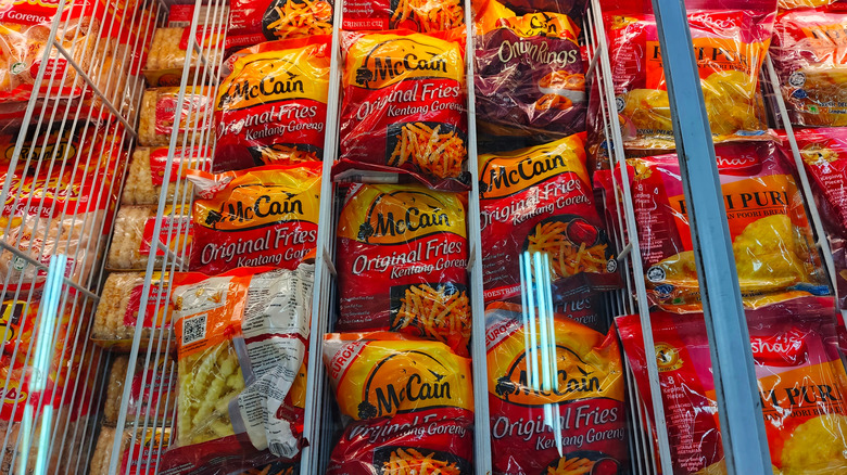 Bags of McCain frozen french fries in a supermarket freezer