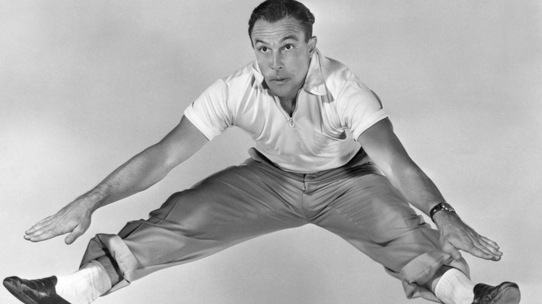 Actor and dancer Gene Kelly leaping into the air.