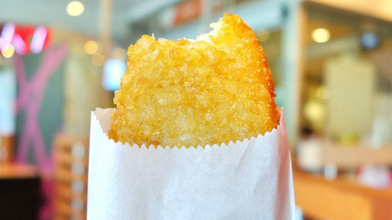 A hash brown with a bite taken out of it