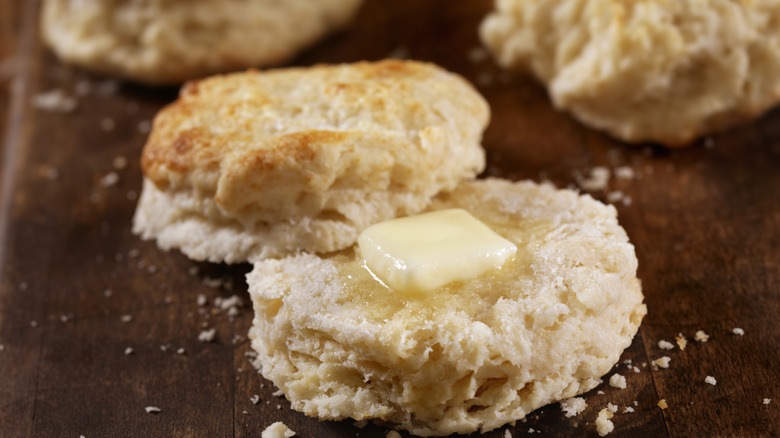 A biscuit cut in half with butter on top