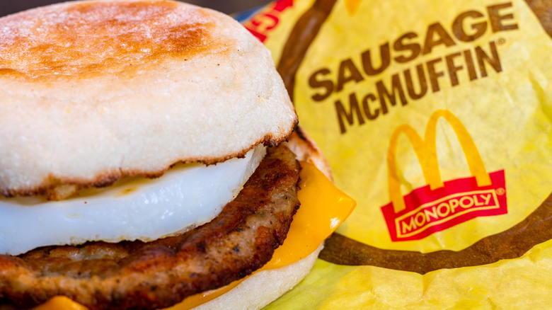 A Sausage McMuffin beside a yellow wrapper
