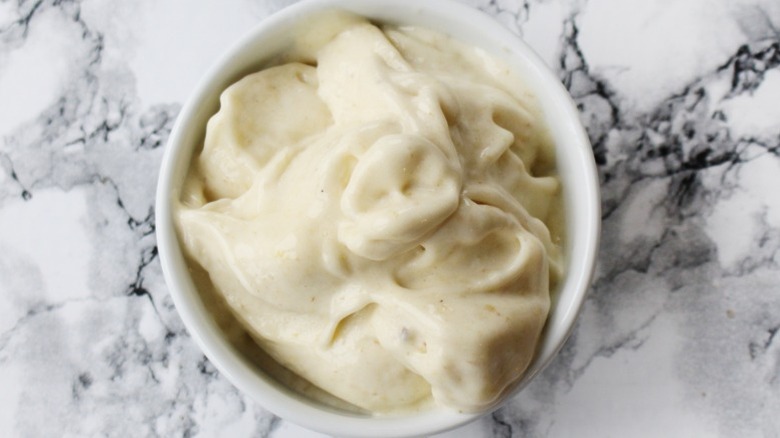 a bowl of healthy banana nice cream on a marble countertop