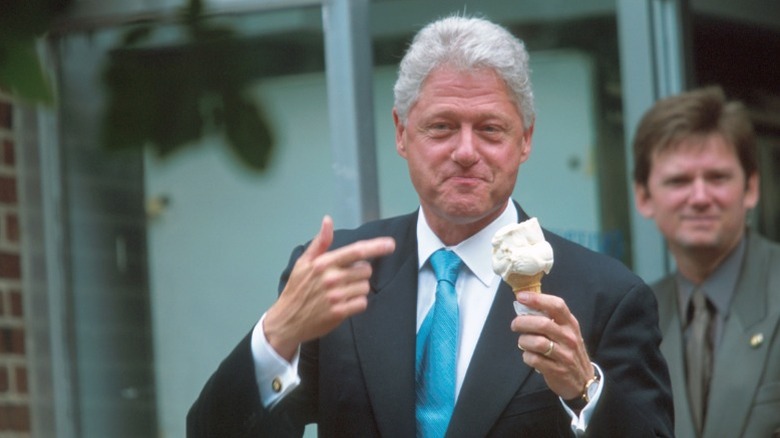 President Bill Clinton pointing to a cone of vanilla ice cream.