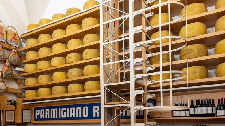 Stacks of Parmigiano Reggiano wheels in a pantry