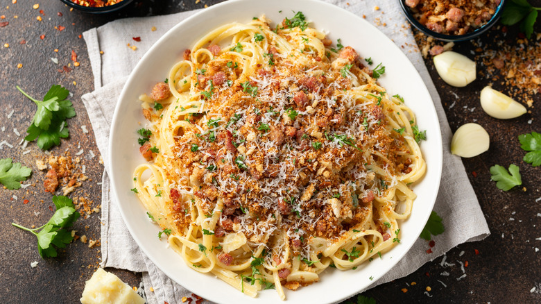 White bowl with spaghetti and toasted breadcrumbs
