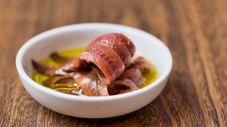 close up of canned anchovy fillets