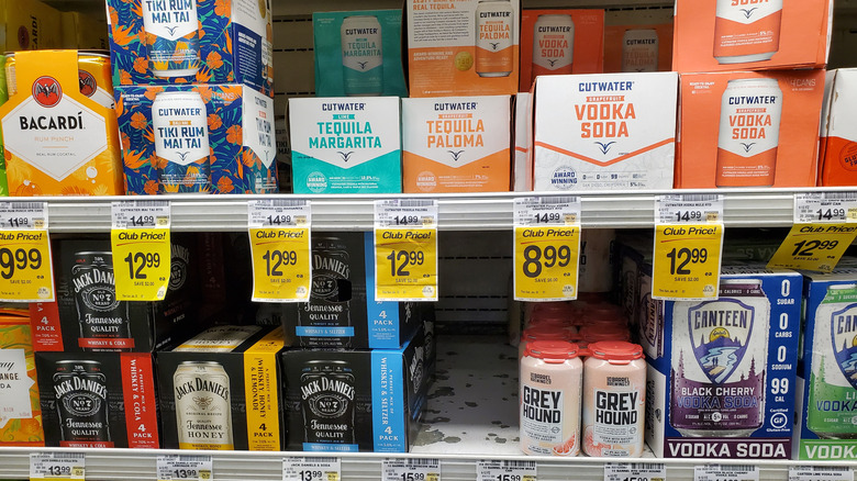 Packs of canned cocktails for sale on grocery shelf