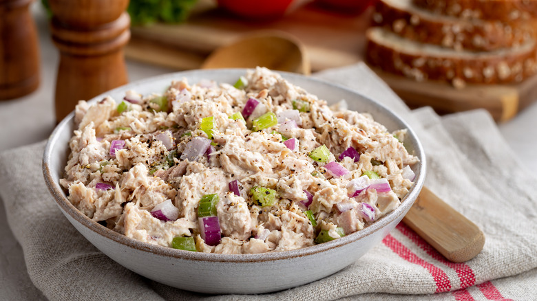 A bowl of tuna salad with celery and onion