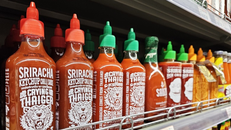 bottles of sriracha on a grocery store shelf
