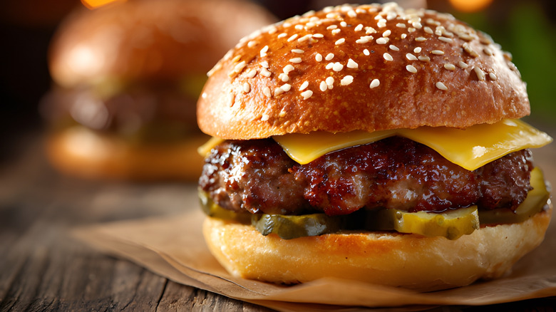 Close up of burger with sliced cheese and pickles