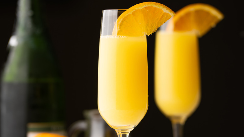 Mimosa cocktails in tall glasses with orange slices