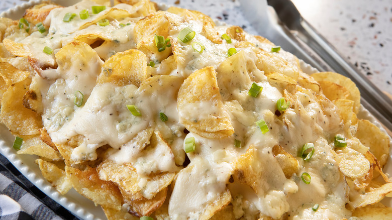 Platter of nachos made with kettle potato chips and white sauce