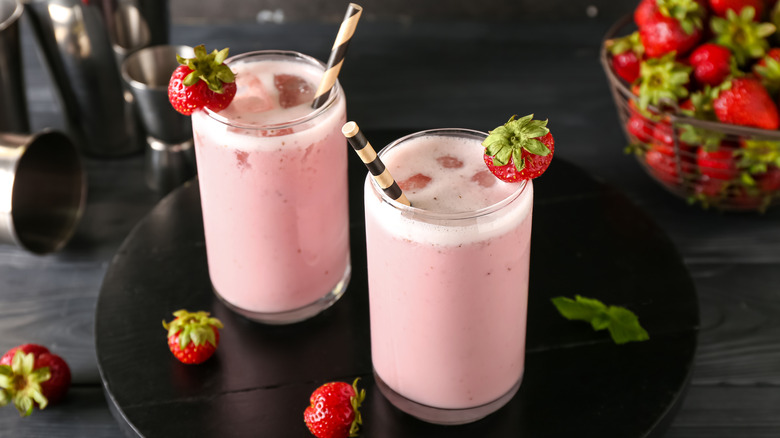 Glasses of strawberry pina coladas with straws