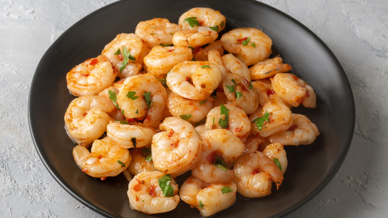 Cooked shrimp with pepper flakes and herbs