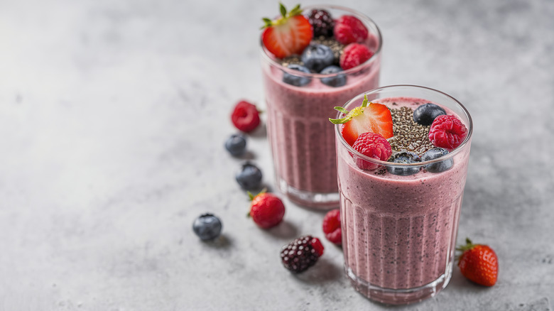 Two glasses of mixed berry smoothie topped with chia seeds
