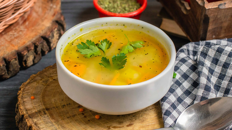 Homemade chicken soup on a wooden board