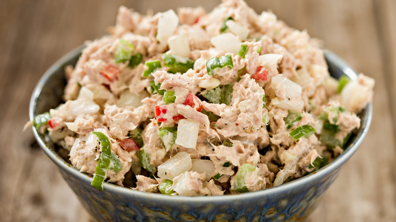 A bowl of tuna salad with chopped vegetables mixed through.