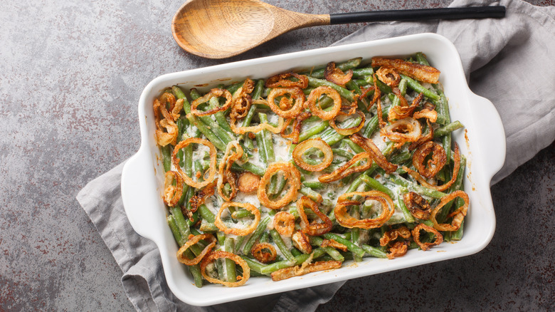 A traditional green bean casserole topped with onions, shot from above