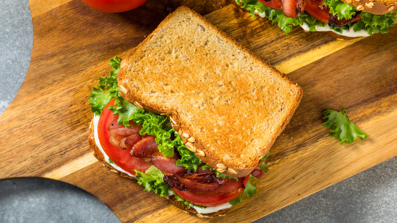 Top-view of a BLT sandwich on wooden cutting board